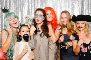 Which Photo Booth Should I Choose - girls in front of photo booth with props